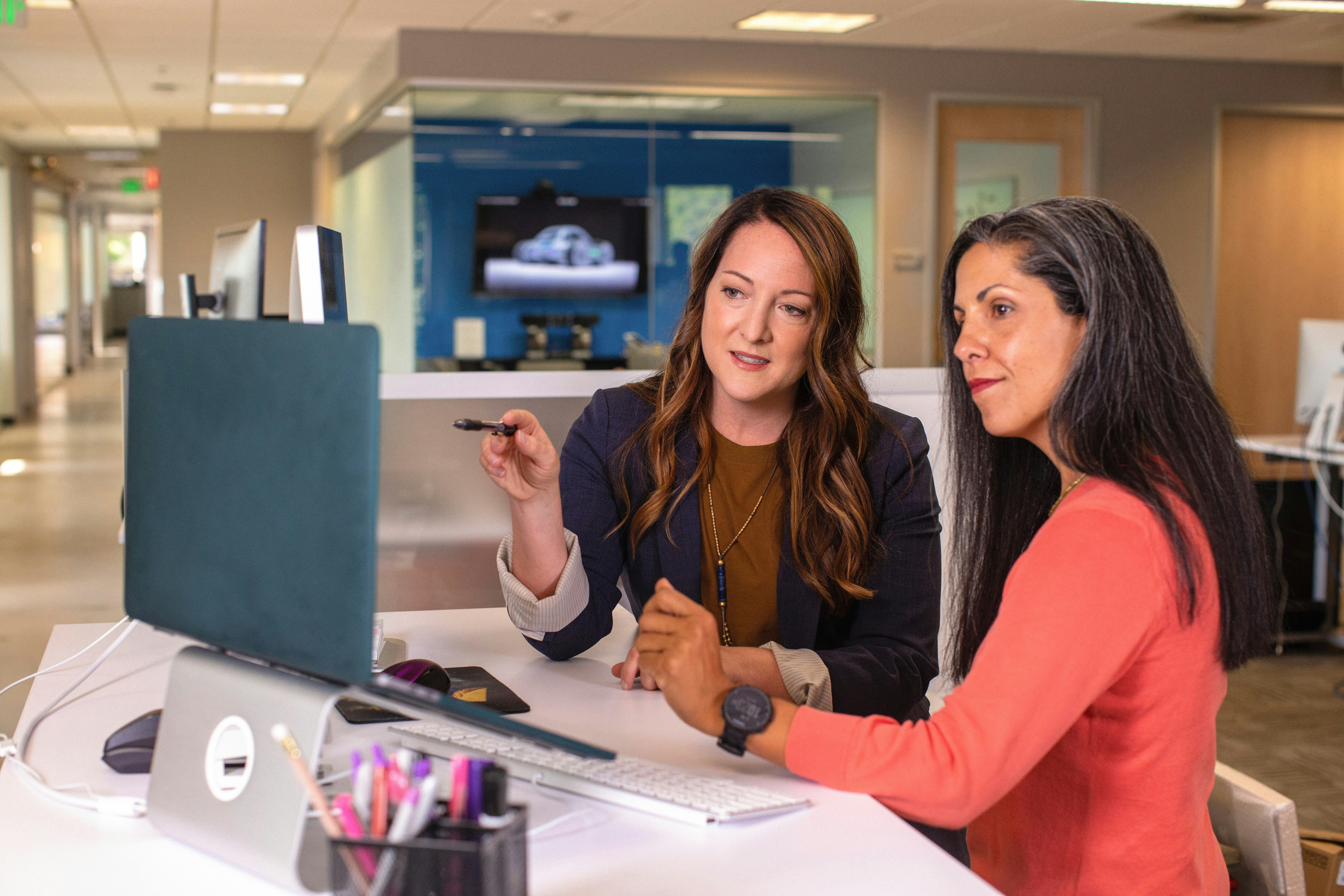Two women at work looking at a computer